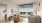 a living room with a large window, a tv and a couch