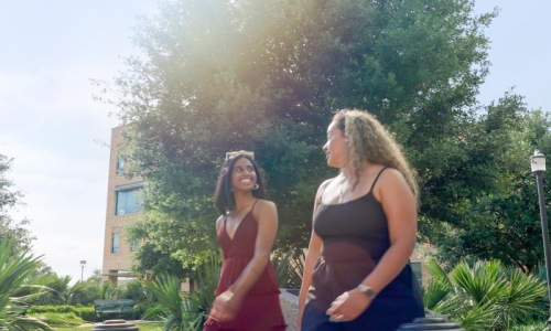 The essence of exceptional living two women standing outside