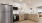 a kitchen with white and wooden cabinets